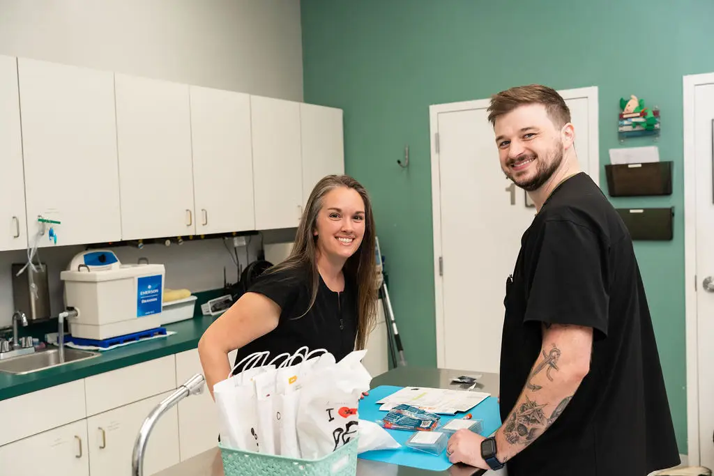 Mixed Pet Veterinary Hospital staff smiling at camera.